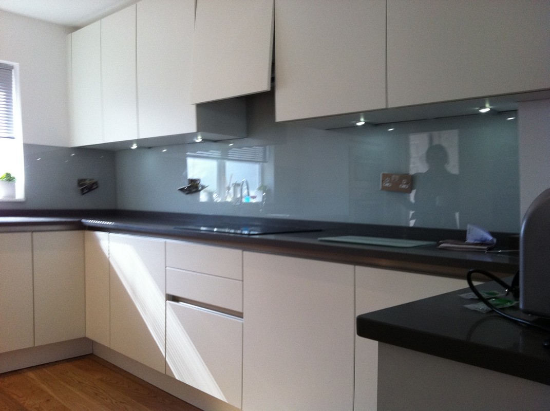 Grey glass kitchen splashback with LED lighting in Bushey
