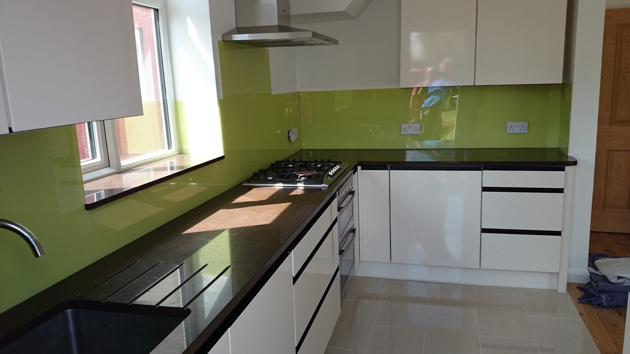Lime green glass kitchen splashback installed by Bushey glaziers