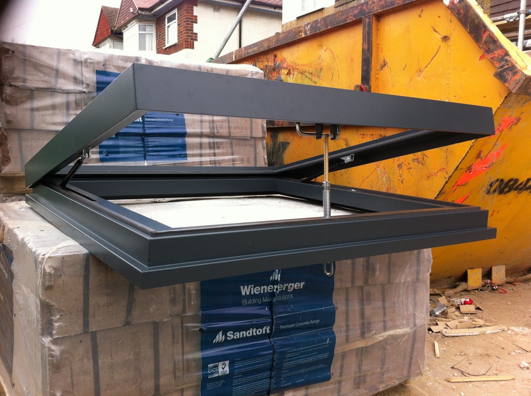 Opening flat roof skylight in anthracite grey installed in Bushey
